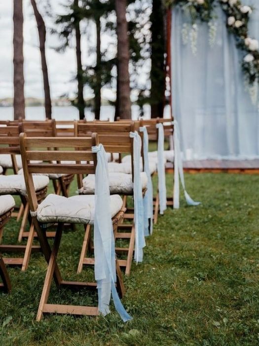 Backyard wedding decor on a budget with ribbon aisle marker